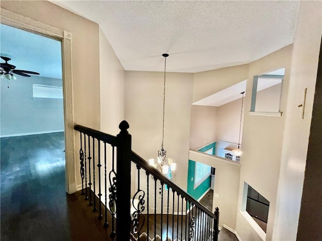 2811 Chatelain Ct Unit A, Independence, MO 64057 - corridor featuring an upstairs landing, a chandelier, a textured ceiling, and wood finished floors