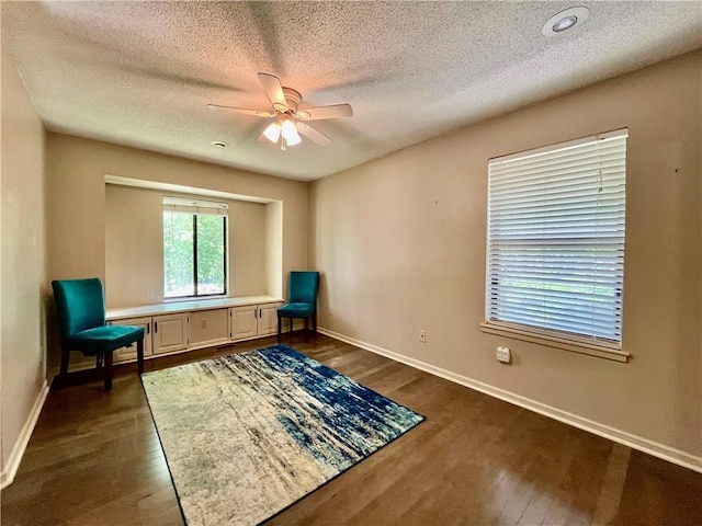 2811 Chatelain Ct Unit A, Independence, MO 64057 - living area with ceiling fan, dark wood-style flooring, and a textured ceiling