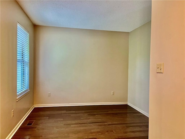 2811 Chatelain Ct Unit A, Independence, MO 64057 - unfurnished room featuring dark wood finished floors and a textured ceiling