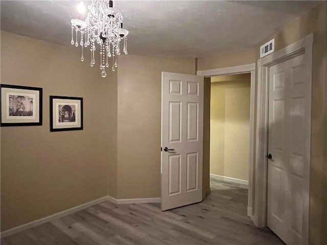 2811 Chatelain Ct Unit A, Independence, MO 64057 - hall featuring a chandelier and wood finished floors