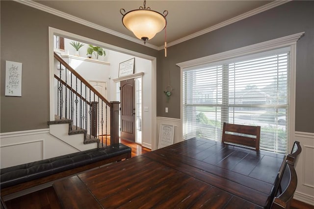 3132 SW Damon Ln, Lees Summit, MO 64082 - unfurnished dining area with a wainscoted wall, crown molding, stairs, a decorative wall, and wood finished floors
