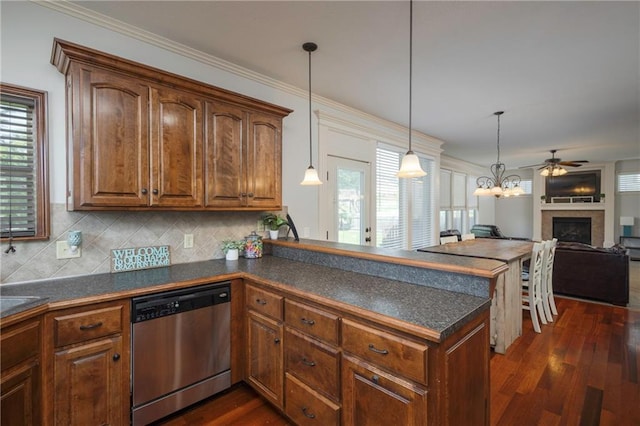 3132 SW Damon Ln, Lees Summit, MO 64082 - kitchen featuring dishwasher, dark countertops, a fireplace, a peninsula, and crown molding
