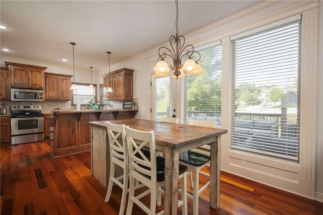 3132 SW Damon Ln, Lees Summit, MO 64082 - dining space featuring dark wood-style floors, a chandelier, crown molding, and recessed lighting