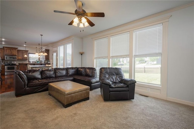 3132 SW Damon Ln, Lees Summit, MO 64082 - living room featuring a chandelier, a ceiling fan, light colored carpet, and crown molding