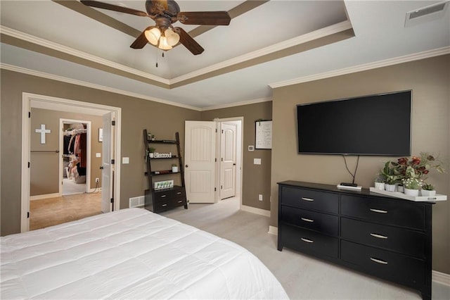3132 SW Damon Ln, Lees Summit, MO 64082 - bedroom featuring a tray ceiling, a walk in closet, ornamental molding, a ceiling fan, and light carpet