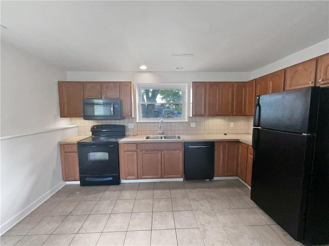 1208 Ranson Pl, Independence, MO 64057 - kitchen with black appliances, tasteful backsplash, light countertops, and light tile patterned flooring