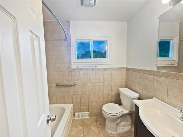 1208 Ranson Pl, Independence, MO 64057 - bathroom with tile walls, tile patterned floors, vanity, shower / bath combination, and a wainscoted wall