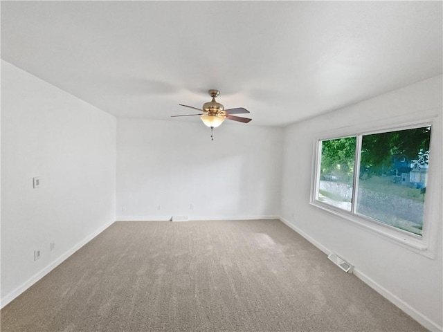 1208 Ranson Pl, Independence, MO 64057 - carpeted spare room with baseboards and a ceiling fan