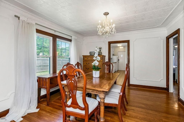 7101 Harrison St, Kansas City, MO 64131 - dining space featuring a chandelier, wood finished floors, and ornamental molding