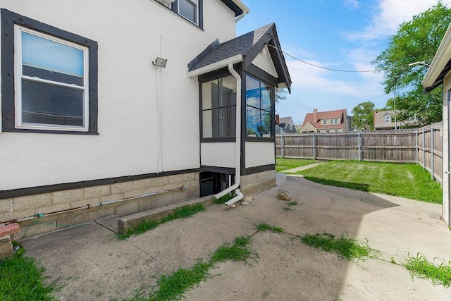 7101 Harrison St, Kansas City, MO 64131 - fenced backyard featuring a sunroom and a patio area