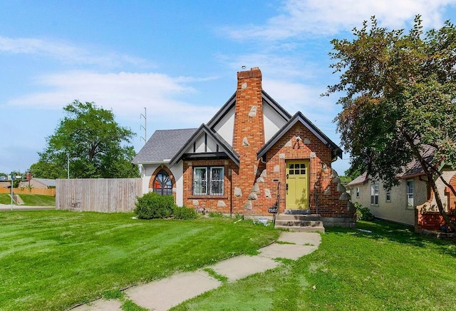 7101 Harrison St, Kansas City, MO 64131 - tudor-style house with a chimney and brick siding
