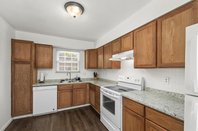 1916 NE Patterson Dr, Lees Summit, MO 64086 - kitchen with white appliances, under cabinet range hood, dark wood finished floors, and brown cabinetry