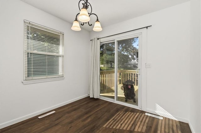 1916 NE Patterson Dr, Lees Summit, MO 64086 - spare room with dark wood-style floors and a chandelier