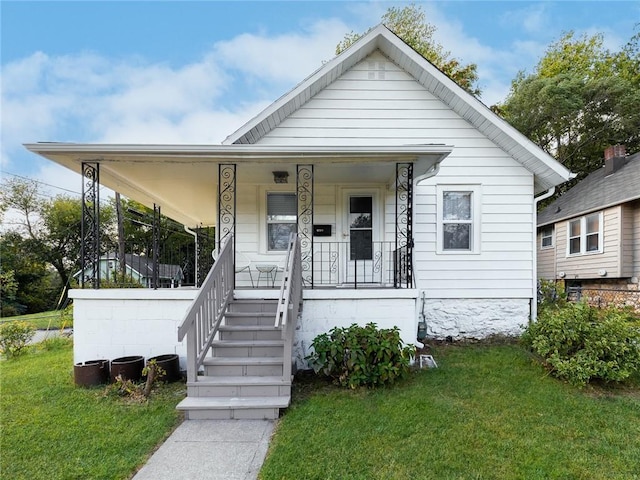 4206 Mission Rd, Kansas City, KS 66103 - view of front of home with a front yard and a porch