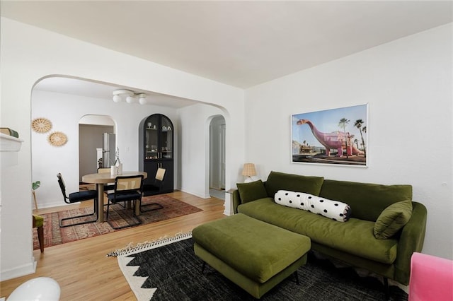 4206 Mission Rd, Kansas City, KS 66103 - living room featuring arched walkways and wood finished floors