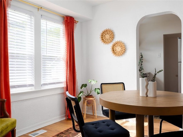 4206 Mission Rd, Kansas City, KS 66103 - dining space featuring arched walkways and wood finished floors