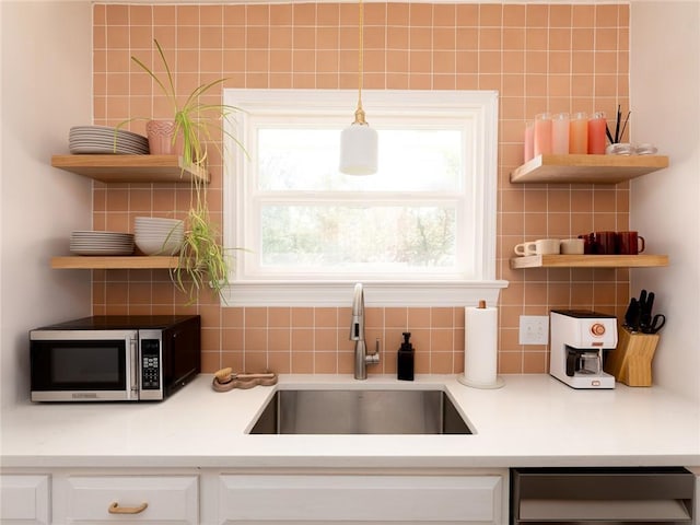 4206 Mission Rd, Kansas City, KS 66103 - kitchen featuring open shelves, stainless steel microwave, tasteful backsplash, dishwasher, and white cabinets