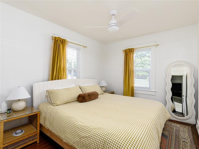 4206 Mission Rd, Kansas City, KS 66103 - bedroom featuring multiple windows, dark wood finished floors, and ceiling fan