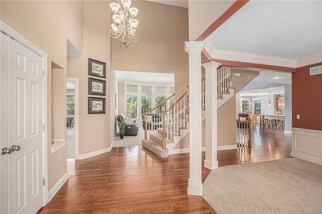 14622 S Garnett St, Olathe, KS 66062 - entryway featuring stairway, plenty of natural light, wood finished floors, crown molding, and a chandelier