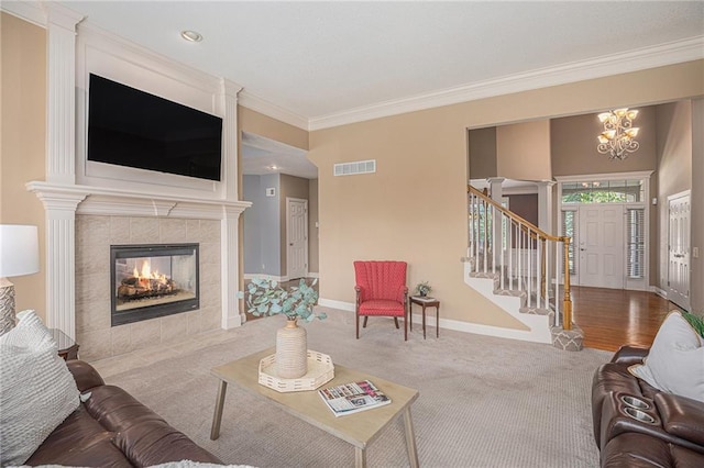 14622 S Garnett St, Olathe, KS 66062 - carpeted living area with a chandelier, stairway, ornamental molding, and a tiled fireplace