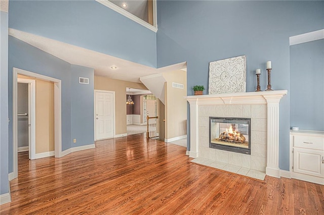 14622 S Garnett St, Olathe, KS 66062 - unfurnished living room with wood finished floors and a tiled fireplace