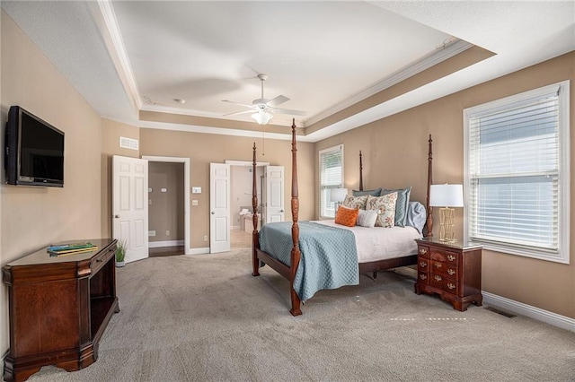14622 S Garnett St, Olathe, KS 66062 - carpeted bedroom with a tray ceiling, ornamental molding, ensuite bathroom, and a ceiling fan