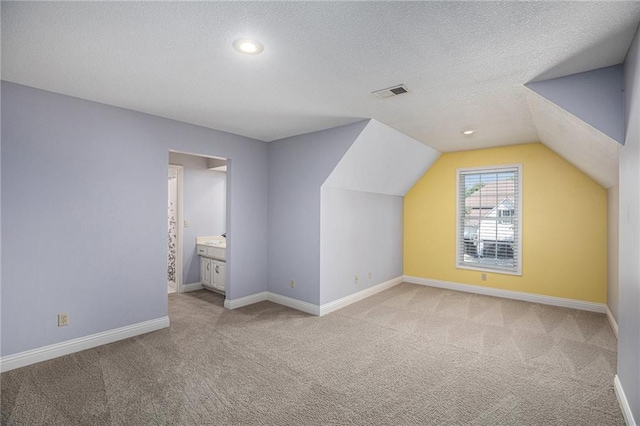 14622 S Garnett St, Olathe, KS 66062 - additional living space with carpet floors, vaulted ceiling, a textured ceiling, and recessed lighting