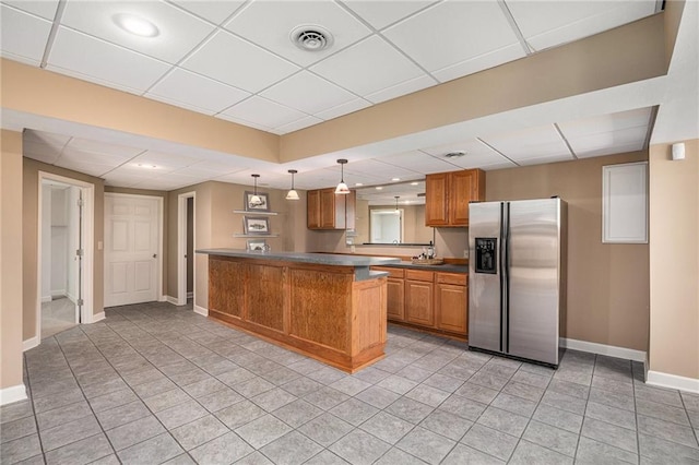 14622 S Garnett St, Olathe, KS 66062 - kitchen featuring stainless steel refrigerator with ice dispenser, brown cabinets, a paneled ceiling, a peninsula, and pendant lighting