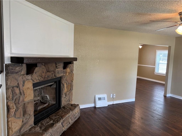 4202 Dr Greaves Rd, Grandview, MO 64030 - unfurnished living room featuring dark wood-style floors, a textured ceiling, a ceiling fan, and a fireplace