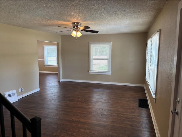 4202 Dr Greaves Rd, Grandview, MO 64030 - empty room featuring dark wood-style flooring, a ceiling fan, and a textured ceiling