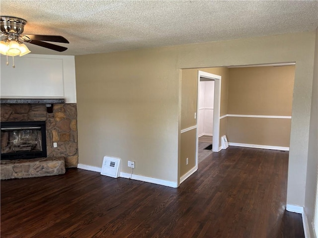 4202 Dr Greaves Rd, Grandview, MO 64030 - unfurnished living room featuring wood finished floors, a ceiling fan, a fireplace, and a textured ceiling
