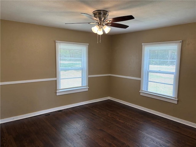 4202 Dr Greaves Rd, Grandview, MO 64030 - spare room featuring plenty of natural light, wood finished floors, and a ceiling fan