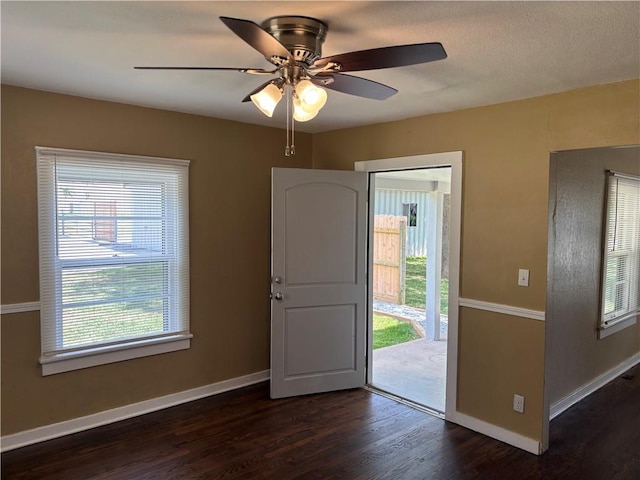 4202 Dr Greaves Rd, Grandview, MO 64030 - foyer entrance featuring dark wood-style floors, plenty of natural light, and ceiling fan