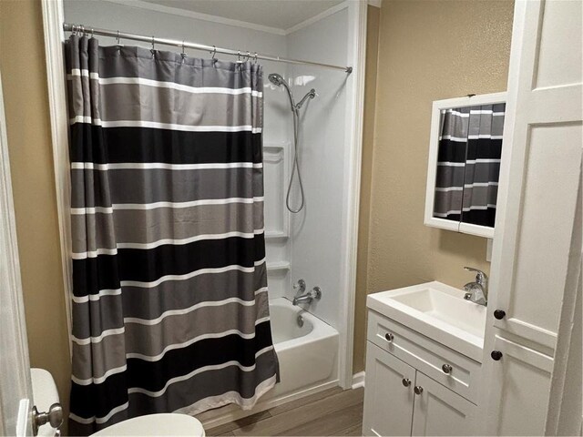 4202 Dr Greaves Rd, Grandview, MO 64030 - full bath featuring vanity, wood finished floors, shower / bath combo with shower curtain, crown molding, and a textured wall
