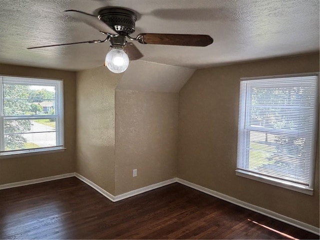4202 Dr Greaves Rd, Grandview, MO 64030 - additional living space with dark wood finished floors, ceiling fan, a textured ceiling, and vaulted ceiling