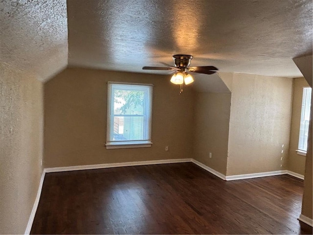 4202 Dr Greaves Rd, Grandview, MO 64030 - bonus room featuring a textured ceiling, dark wood finished floors, and ceiling fan