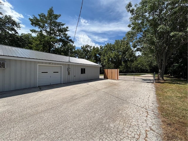 4202 Dr Greaves Rd, Grandview, MO 64030 - garage with a gate and view of scattered trees