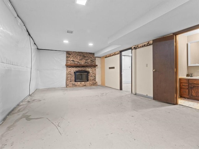 1490 216th St, Lathrop, MO 64465 - unfurnished living room with a fireplace, concrete floors, and recessed lighting