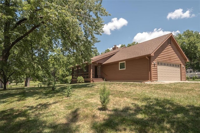 918 King St, Baldwin City, KS 66006 - view of front of house with a front lawn, a chimney, and an attached garage