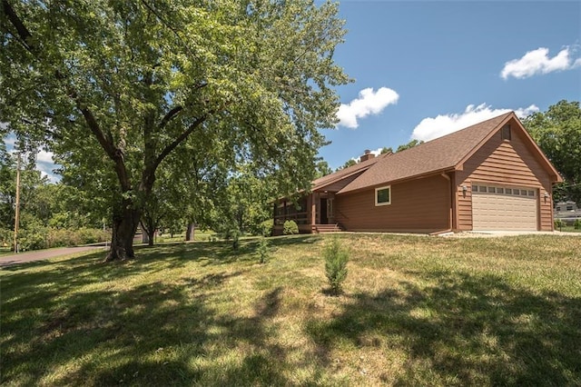 918 King St, Baldwin City, KS 66006 - view of home's exterior featuring a lawn, a chimney, and an attached garage