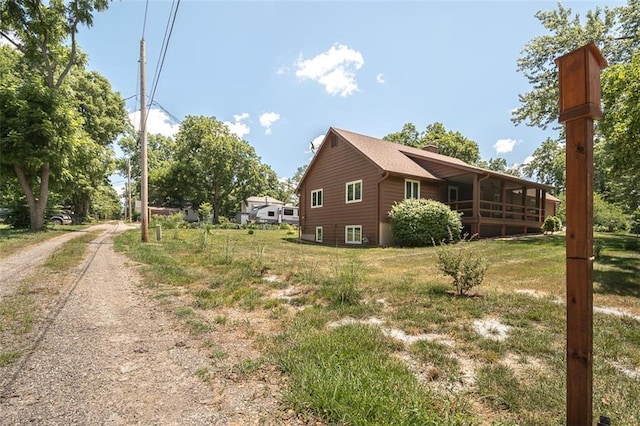 918 King St, Baldwin City, KS 66006 - view of side of home with driveway and a yard