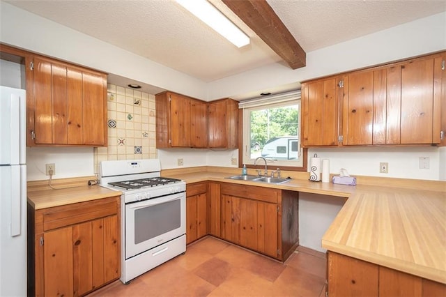 918 King St, Baldwin City, KS 66006 - kitchen with white appliances, light countertops, beam ceiling, brown cabinetry, and tasteful backsplash