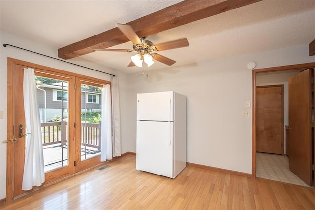 918 King St, Baldwin City, KS 66006 - kitchen featuring freestanding refrigerator, light wood-style flooring, beam ceiling, and a ceiling fan