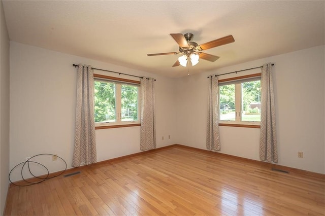 918 King St, Baldwin City, KS 66006 - unfurnished room featuring light wood finished floors and ceiling fan
