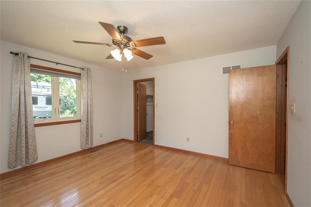 918 King St, Baldwin City, KS 66006 - empty room with light wood-style floors, a ceiling fan, and a textured ceiling