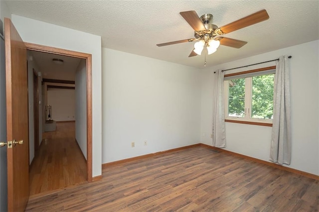 918 King St, Baldwin City, KS 66006 - unfurnished room featuring wood finished floors, ceiling fan, and a textured ceiling