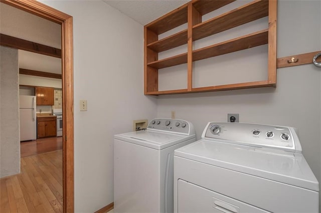 918 King St, Baldwin City, KS 66006 - washroom featuring washing machine and clothes dryer and light wood-style floors