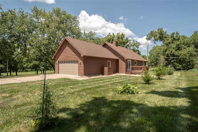 918 King St, Baldwin City, KS 66006 - view of side of home featuring concrete driveway, a chimney, and a lawn