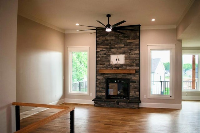 12820 N Arbor Way, Platte City, MO 64079 - unfurnished living room featuring crown molding, wood finished floors, a ceiling fan, a stone fireplace, and recessed lighting