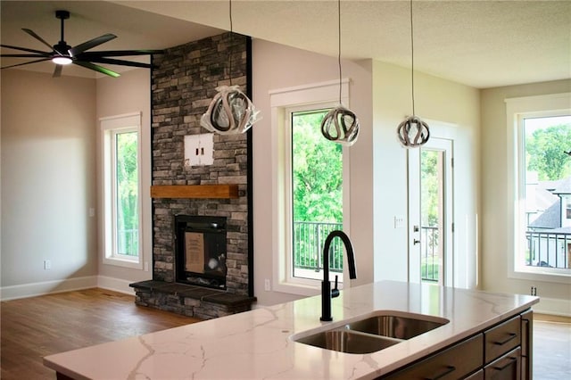 12820 N Arbor Way, Platte City, MO 64079 - kitchen with plenty of natural light, wood finished floors, and light stone counters
